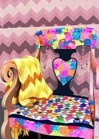 a colorful chair in front of a patterned wall